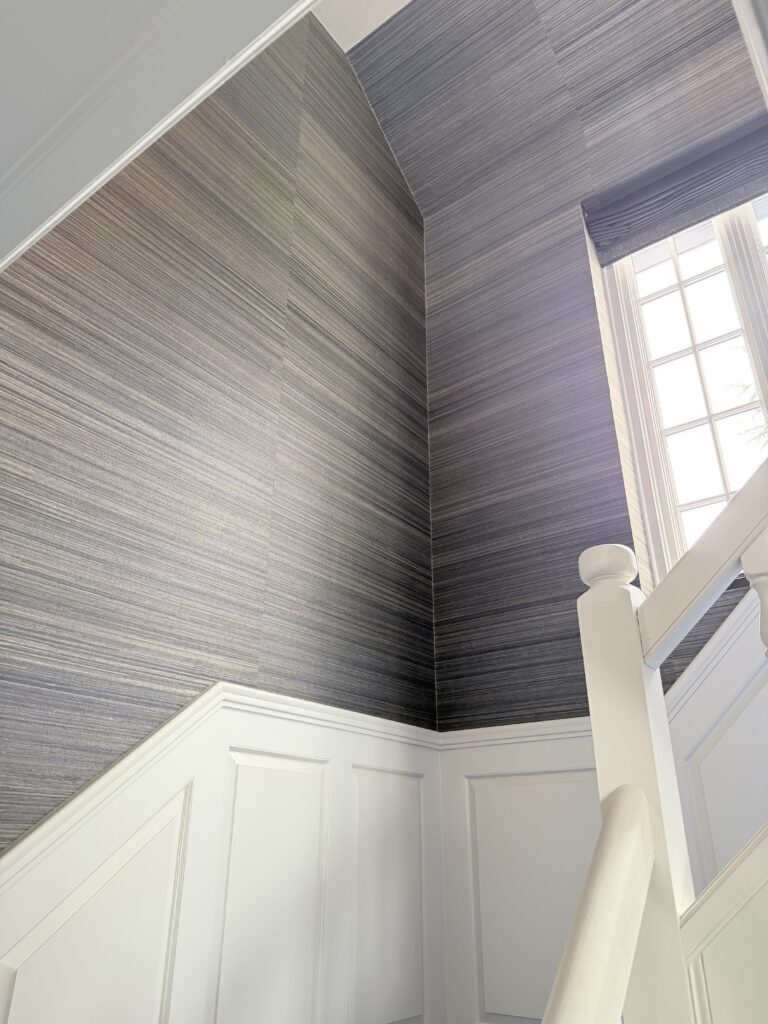 Wallpaper installation project with textured stair hall wallcovering